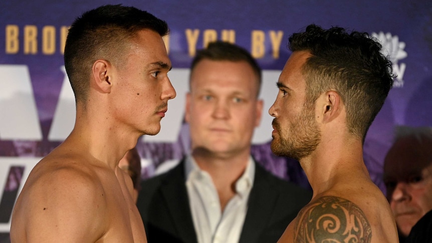 Tim Tszyu and Bowyn Morgan stand face to face at the weigh-in before their boxing fight. Promoter Ben Damon is in the middle.