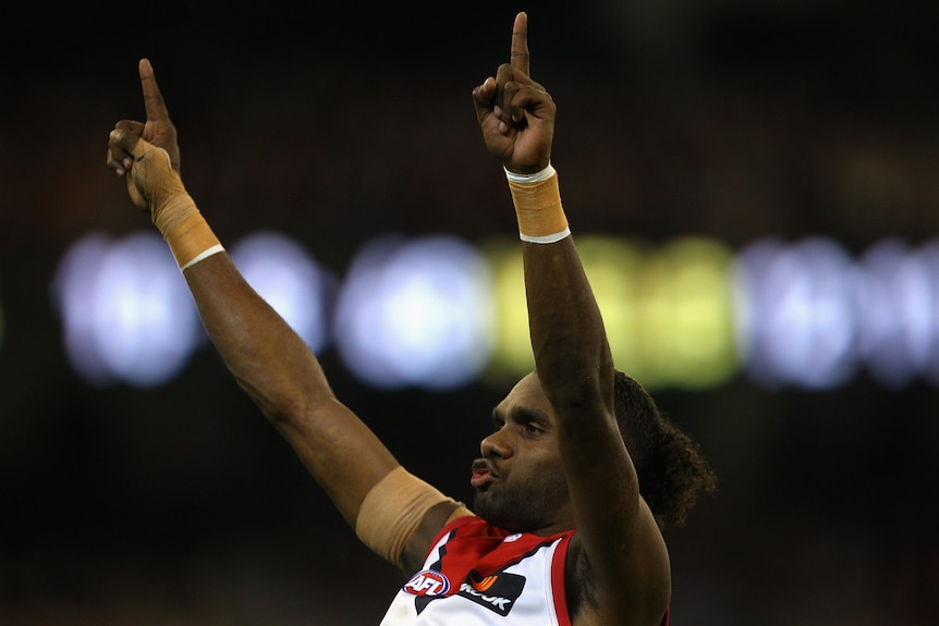 AFL player celebrating after kicking a goal during a match