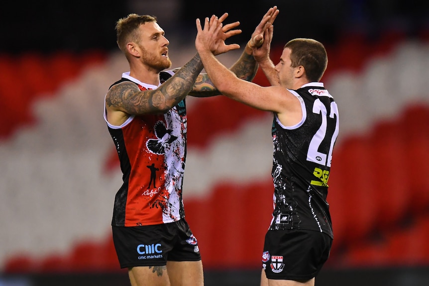 Tim Membrey and Jack Higgins high-five after a St Kilda goal against North Melbourne.