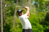Australian golfer Jason Day, following through with an iron shot, on the tee in a tournament.