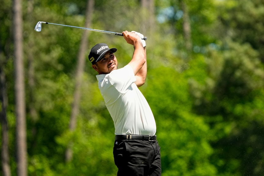 Australian golfer Jason Day, following through with an iron shot, on the tee in a tournament.
