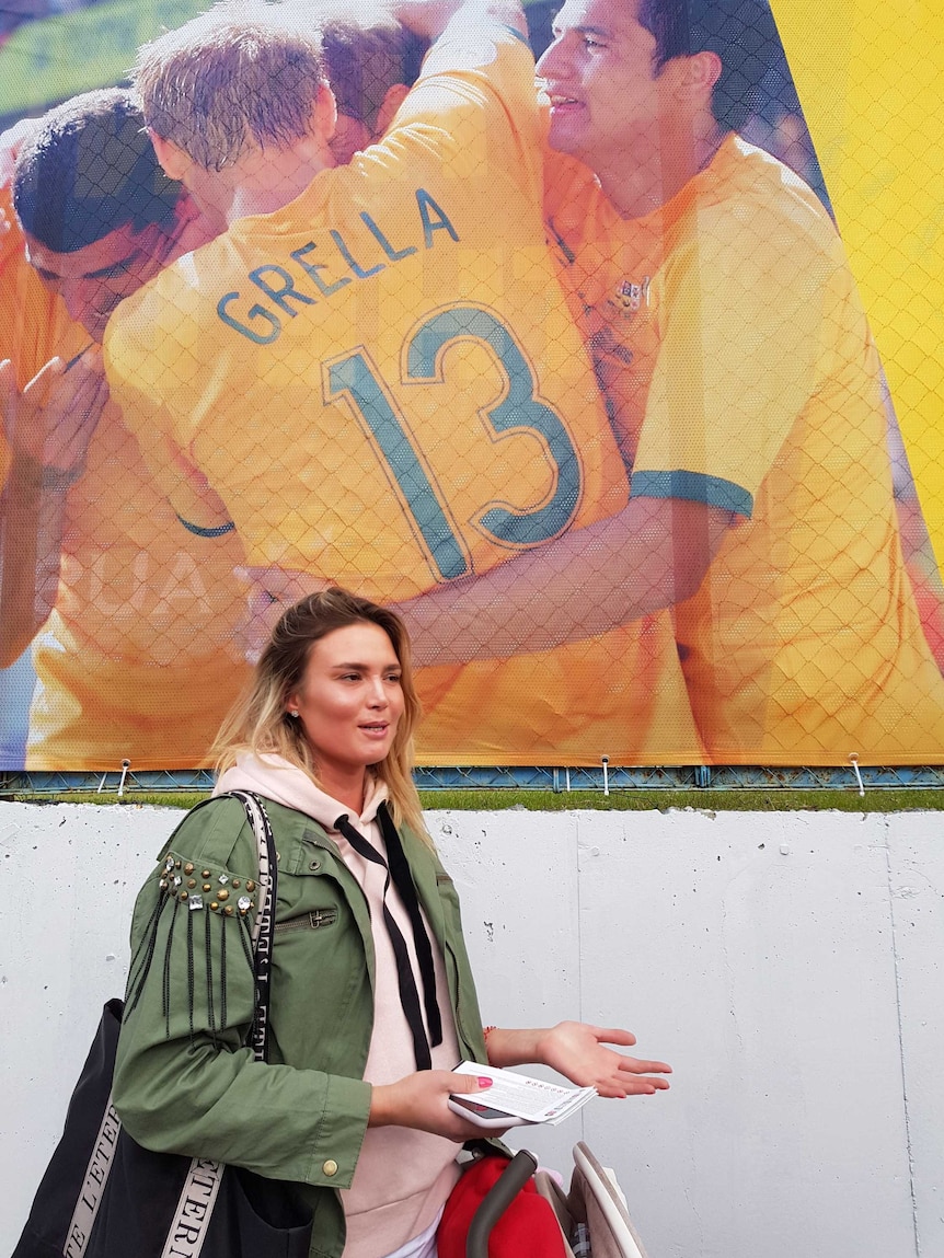 Woman stands in front of Socceroos poster in Kazan, Russia on June 11, 2018.