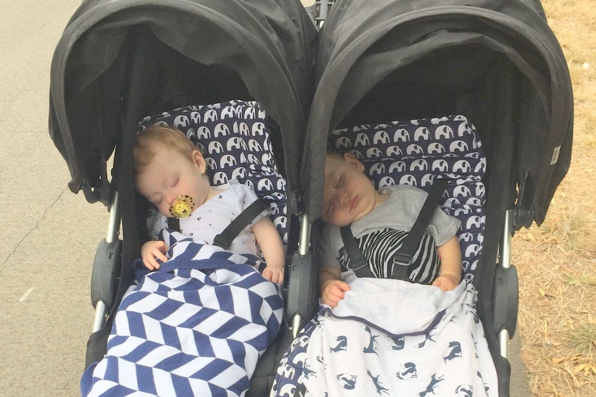 Sleeping babies out for a walk in the pram