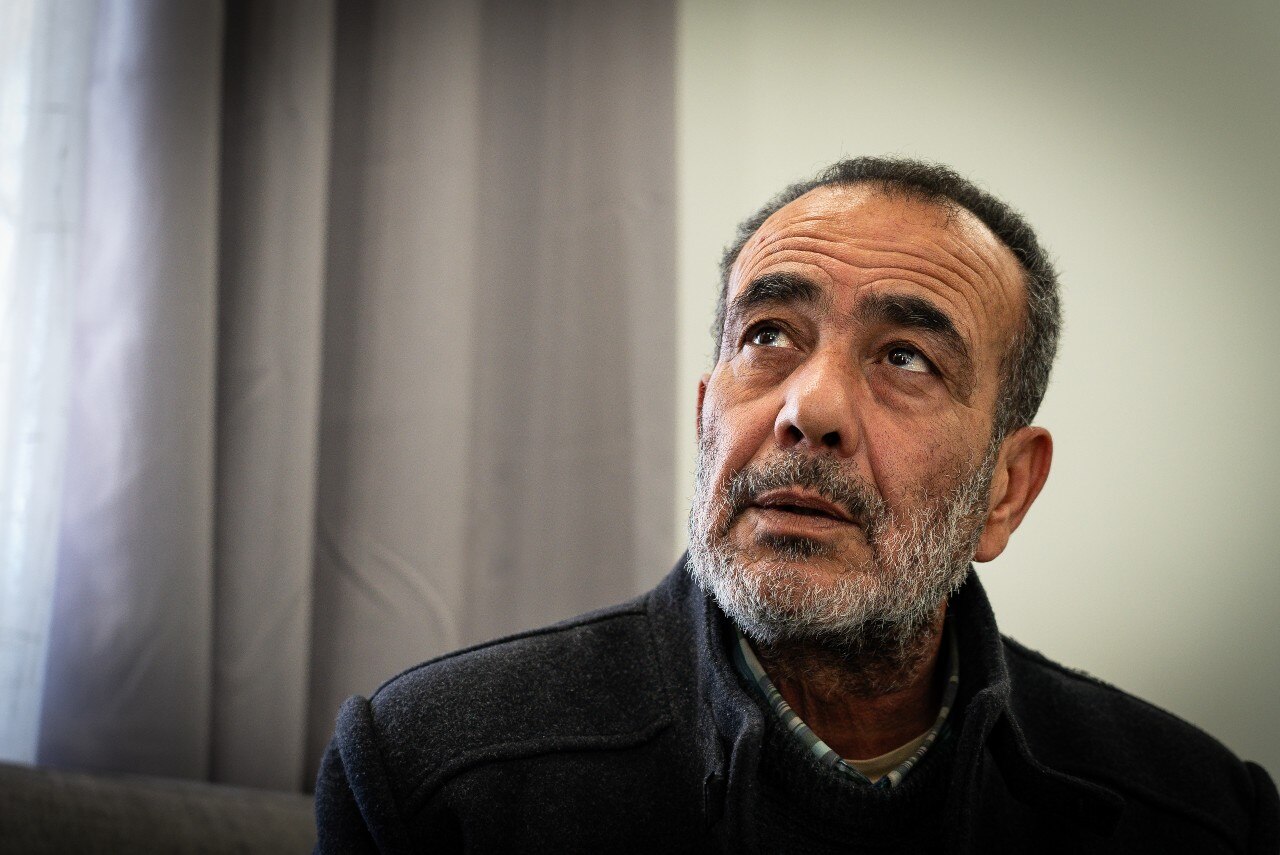 A man looking on with a neutral expression