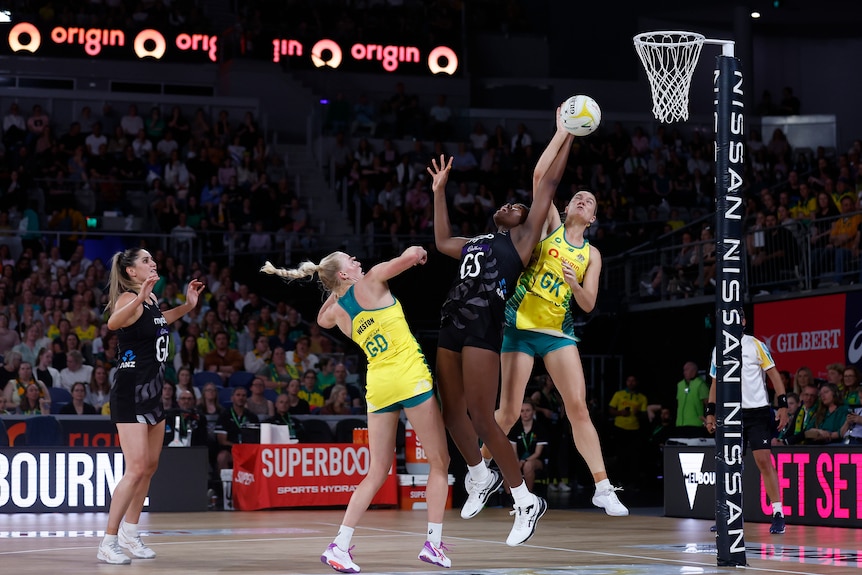 Bruce, Weston and Nweke battle for the ball in the air as it sails into the netball circle