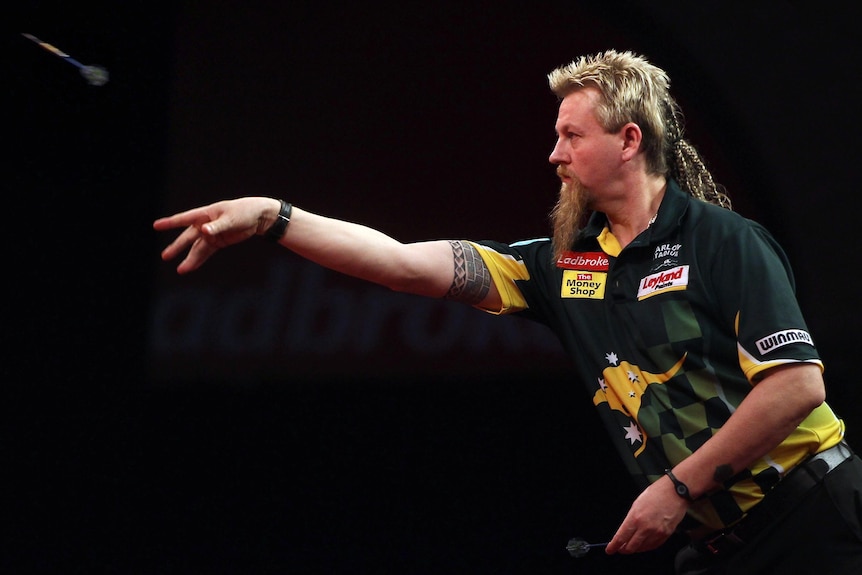 Simon Whitlock throws during his semi-final against Andy Hamilton at the World Darts Championships.