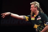 Simon Whitlock throws during his semi-final against Andy Hamilton at the World Darts Championships.