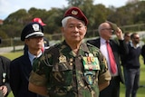 Former South Vietnamese soldier Ha-To Ha stands to attention.