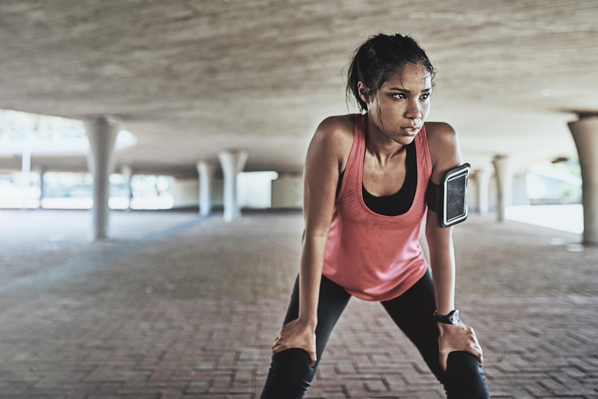 Young woman taking a break after exercising outdoors