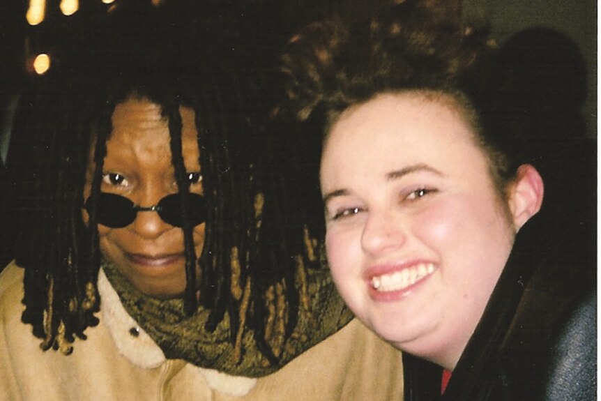 Whoopi Goldberg and Rebel Wilson smiling, Whoop with sunglasses on her nose and locs, Rebel with brown curly short hair