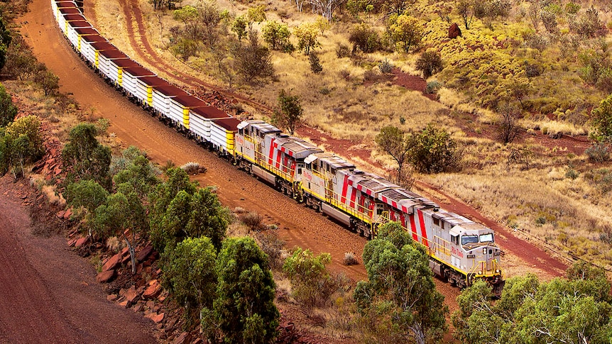 An iron ore train snakes its way through the Pilbara