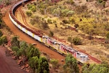 An iron ore train snakes its way through the Pilbara