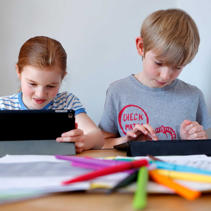 children learning with computer tablets