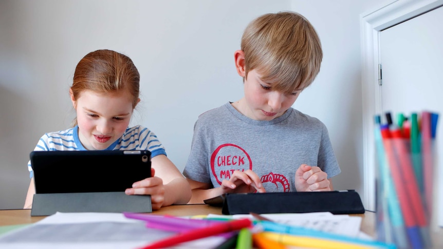 children learning with computer tablets