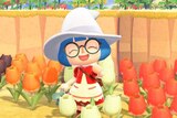 A screenshot from Animal Crossing of a girl surrounded by many different coloured flowers