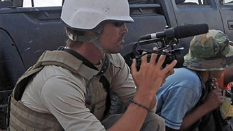 James Foley crouches while filming in Libya AFP: Aris Messinis