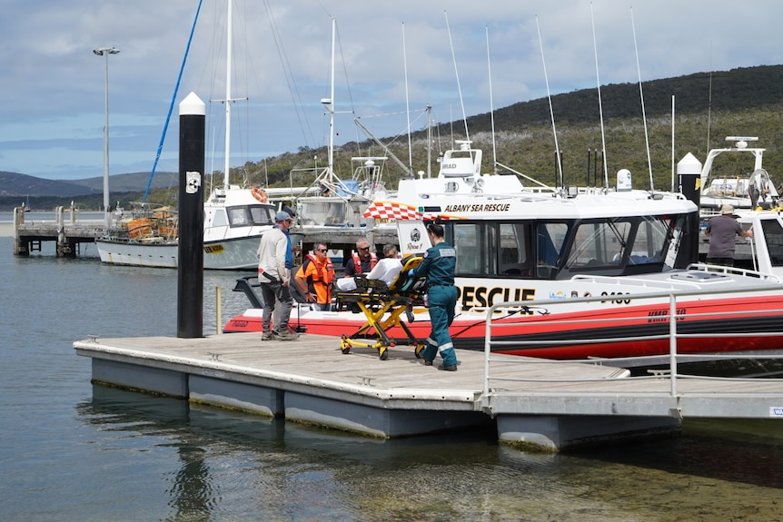 Boats in a marina with paramedic close by.