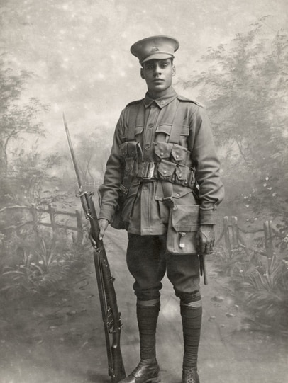 A black and white photo of a man in military uniform.