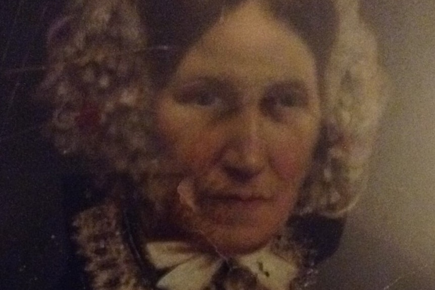 Photograph of a woman's face with a headdress