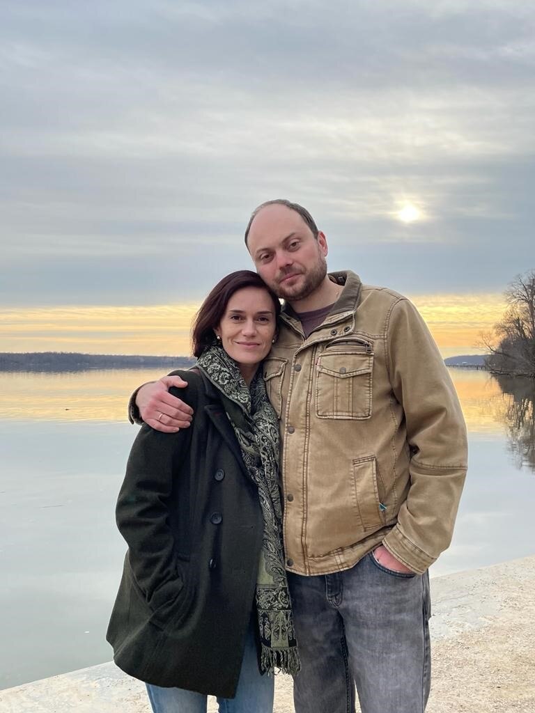 A woman and man with their arms around each other.