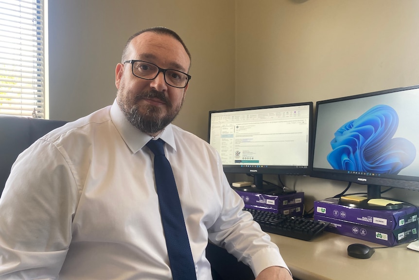 A man sitting at his work desk.