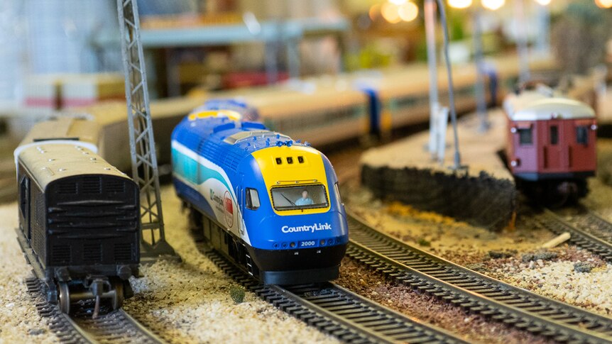 A miniature Countrylink XPT train on a model railway set.