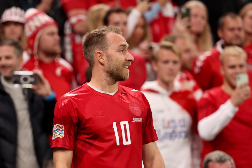 Christian Eriksen smiles in front of fans