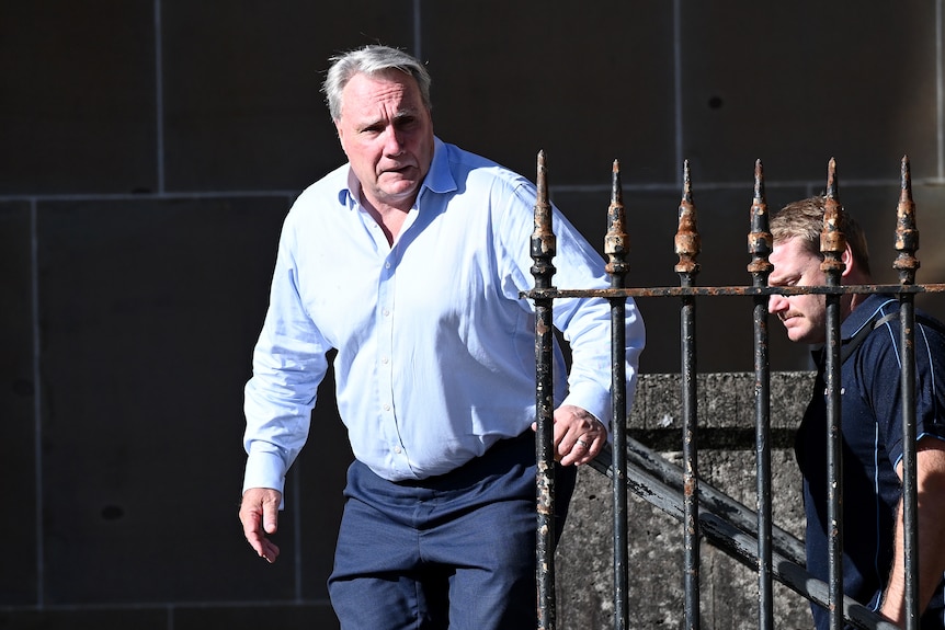 a man walking up a set of stairs outdoors