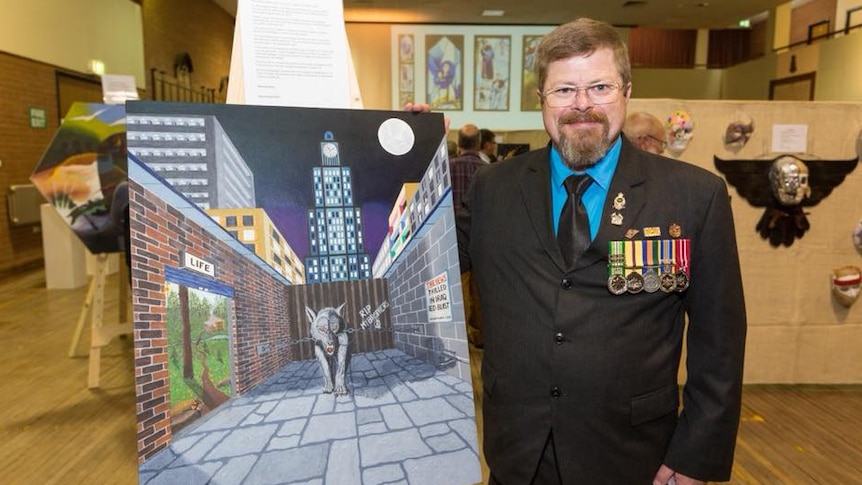 Adelaide veteran David Gillard stands next to one of his art pieces