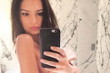 Model Emily Ratajkowski poses for a topless selfie.