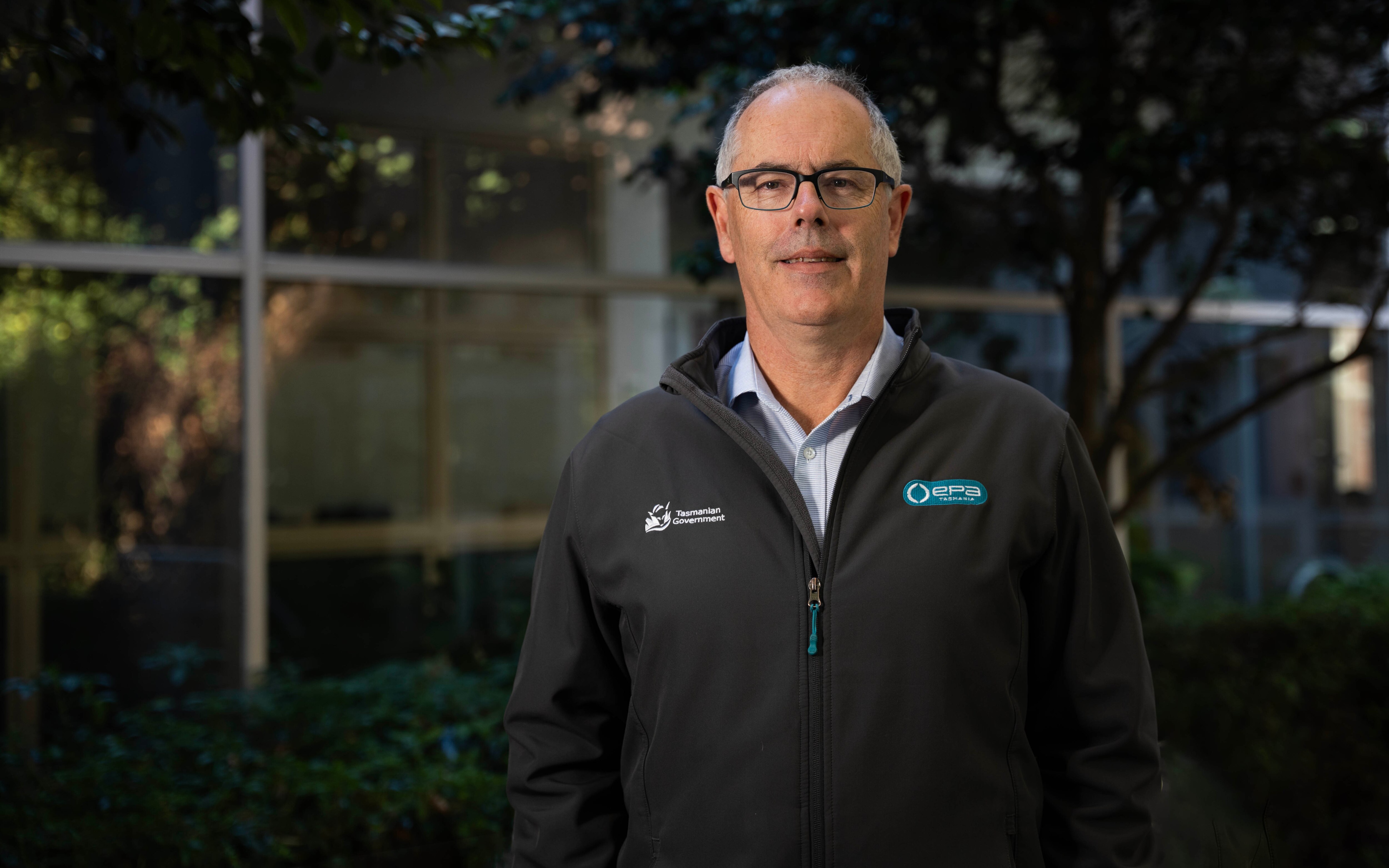 A man with glasses looking at the camera.