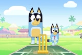 Bluey holds a cricket ball next to her dad, Bandit.