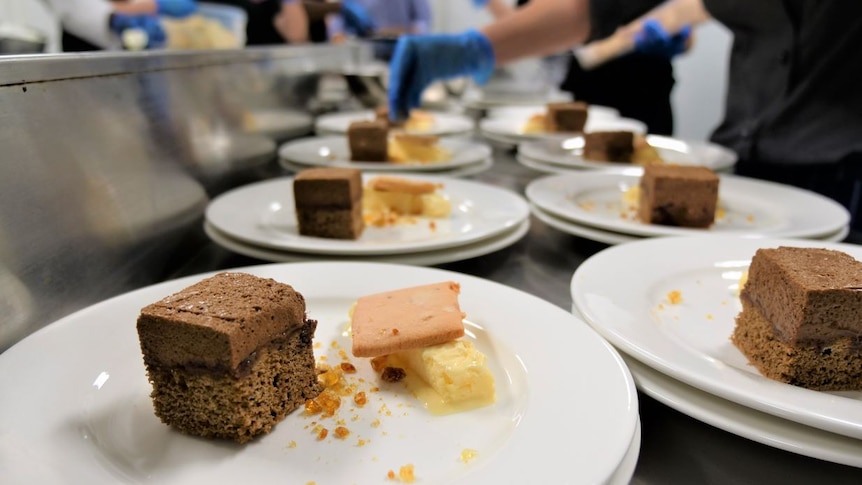 Row of desserts being prepared.