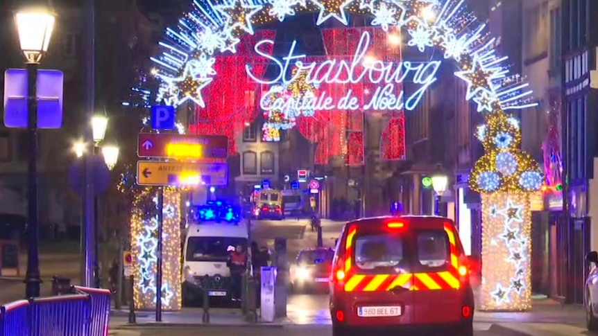 A still from a video shows emergency vehicles on the street and Christmas lights.
