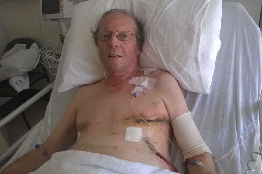 Dr Carey Denholm lying in bed fives days after a double lung transplant