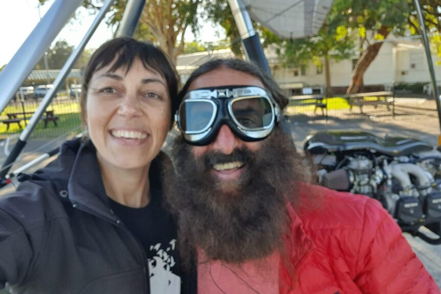 A photo of Milly, a brown haired smiling woman, with Costa Georgiadis from gardening australia who is wearing goggles
