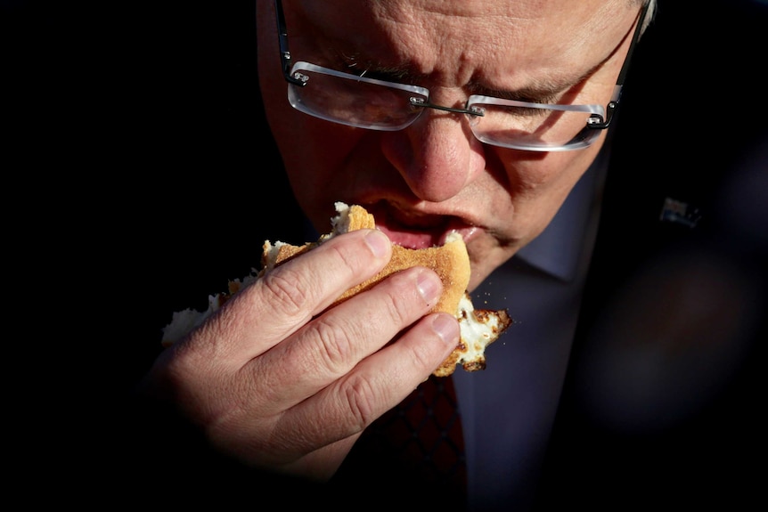 Close up of Scott Morrison eating an egg and bacon roll