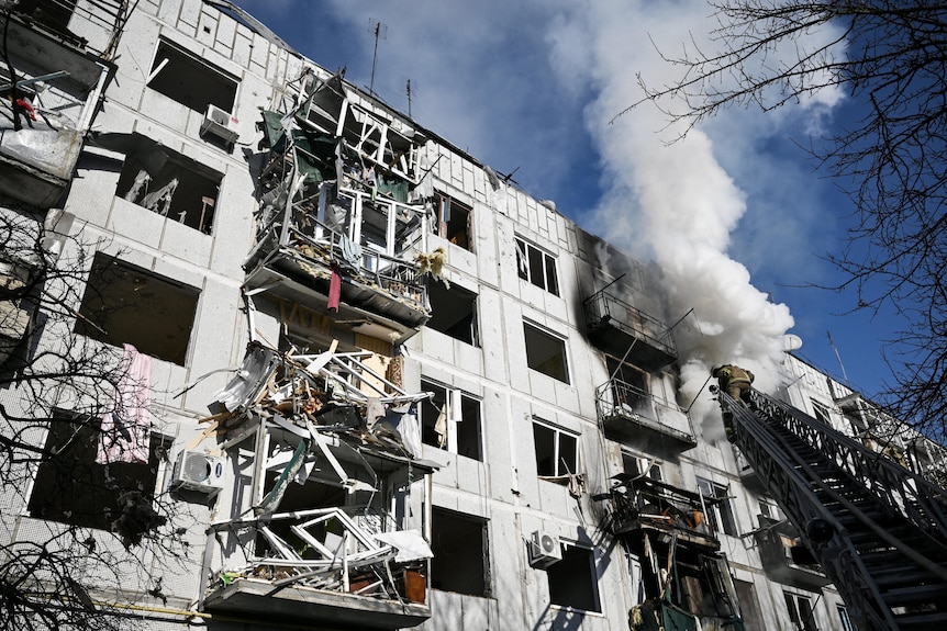 Smoke billows from a building recently shelled