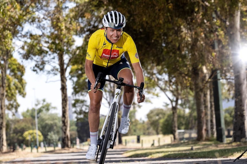 A woman in yellow lycra riding a bike