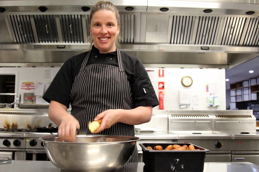 Chef Jessica Ardaiz prepares food in a kitchen
