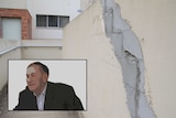 A cracked wall at an apartment complex and a filtered image of Ivan Bulum in the corner.