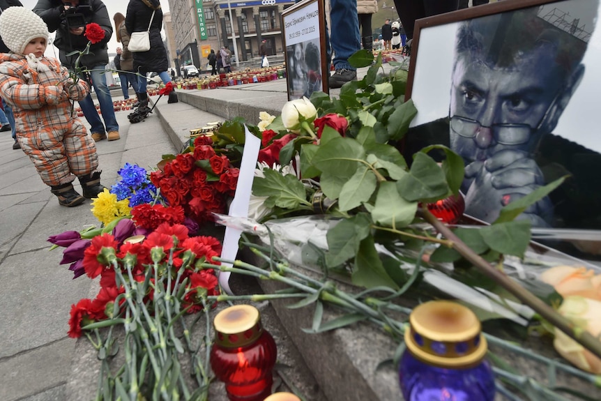Child puts flower at scene of Boris Nemtsov shooting