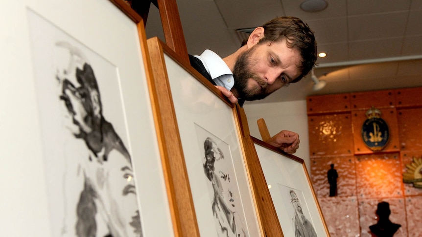 Official Australian war artist Ben Quilty displays some of his work at the Australian War Memorial in Canberra