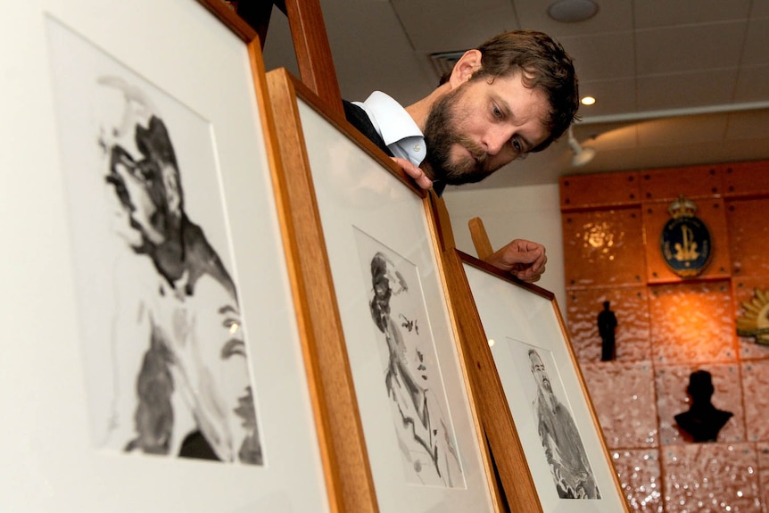 Official Australian war artist Ben Quilty displays some of his work at the Australian War Memorial in Canberra