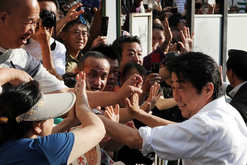 Japanese prime minister Shinzo Abe greets supporters in Tokyo.