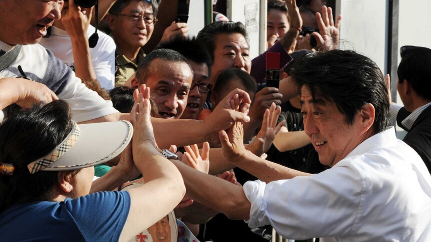 Shinzo Abe greets supporters in Tokyo on the final day of the campaign.