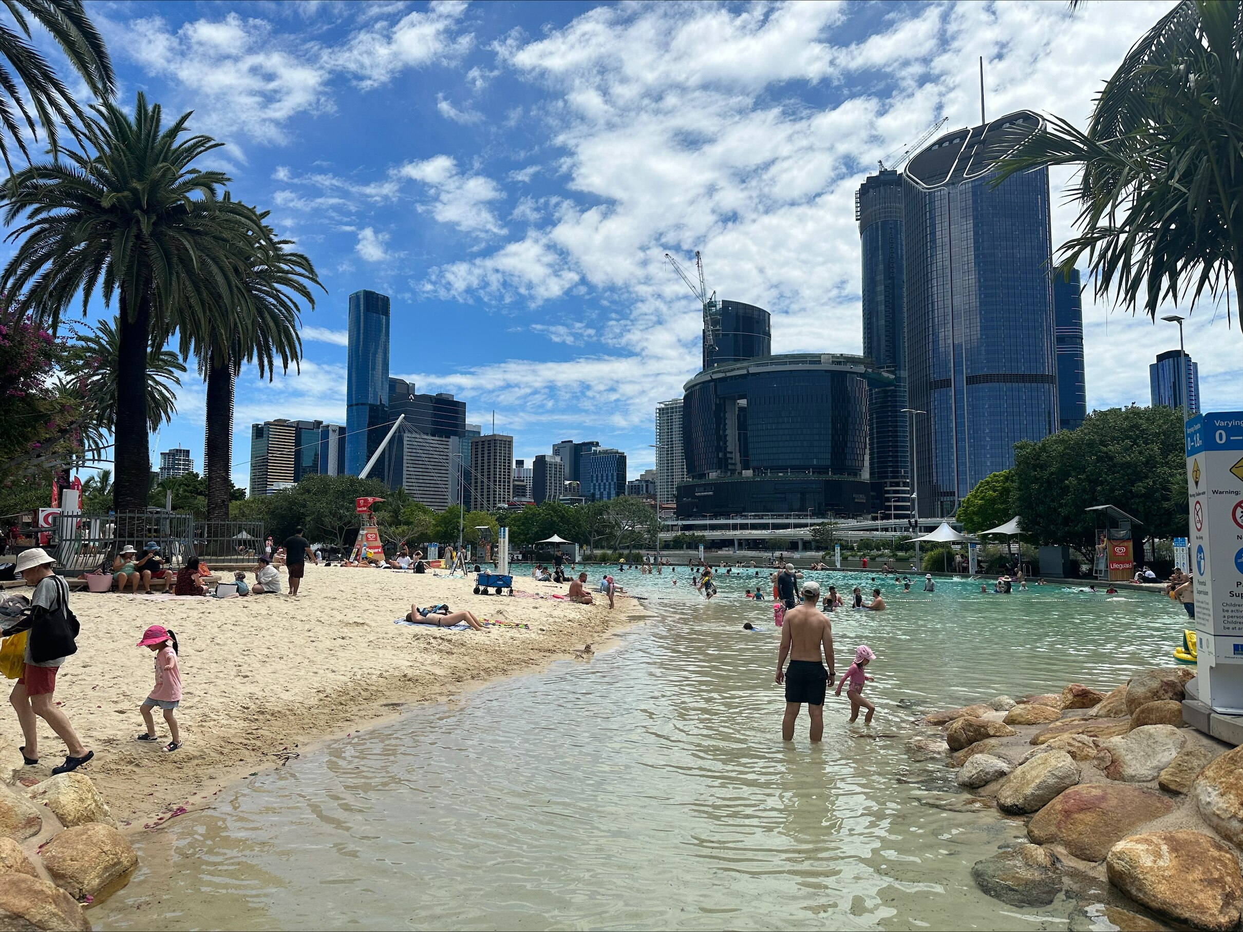 swimmers at South Bank artificial beach on christmas day head out for an early morning dip before lunch