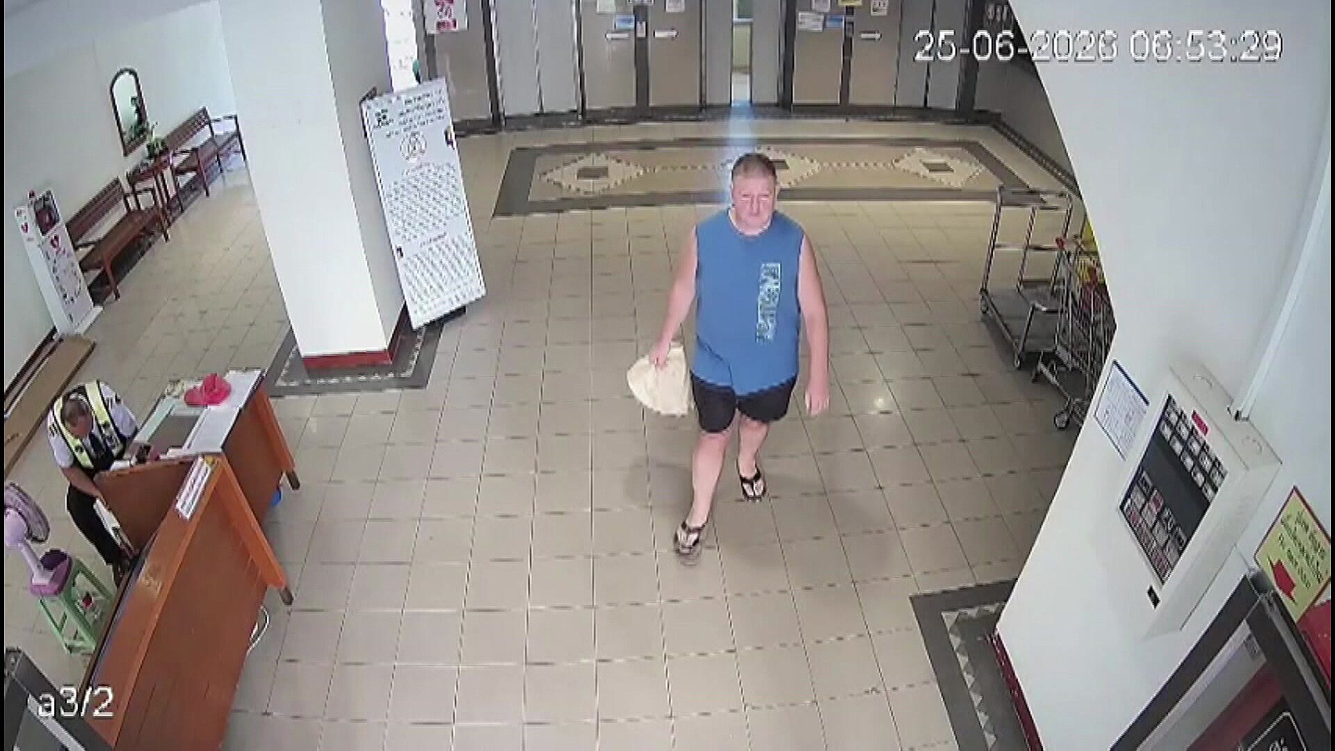 Simon Carman walks through foyer of building in Pattaya - ABC News