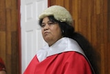 An I-Kiribati woman wearing a lawyers wig and red robe at an official ceremony 