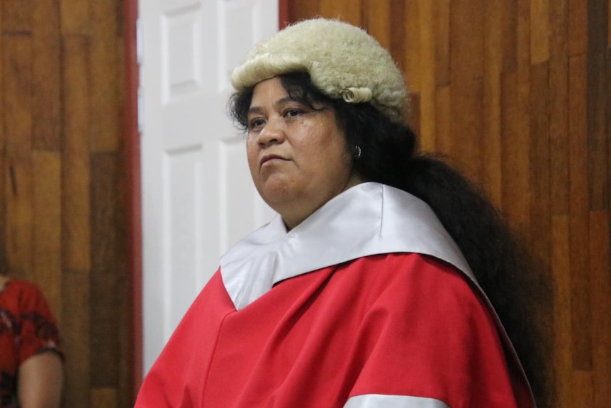 An I-Kiribati woman wearing a lawyers wig and red robe at an official ceremony 
